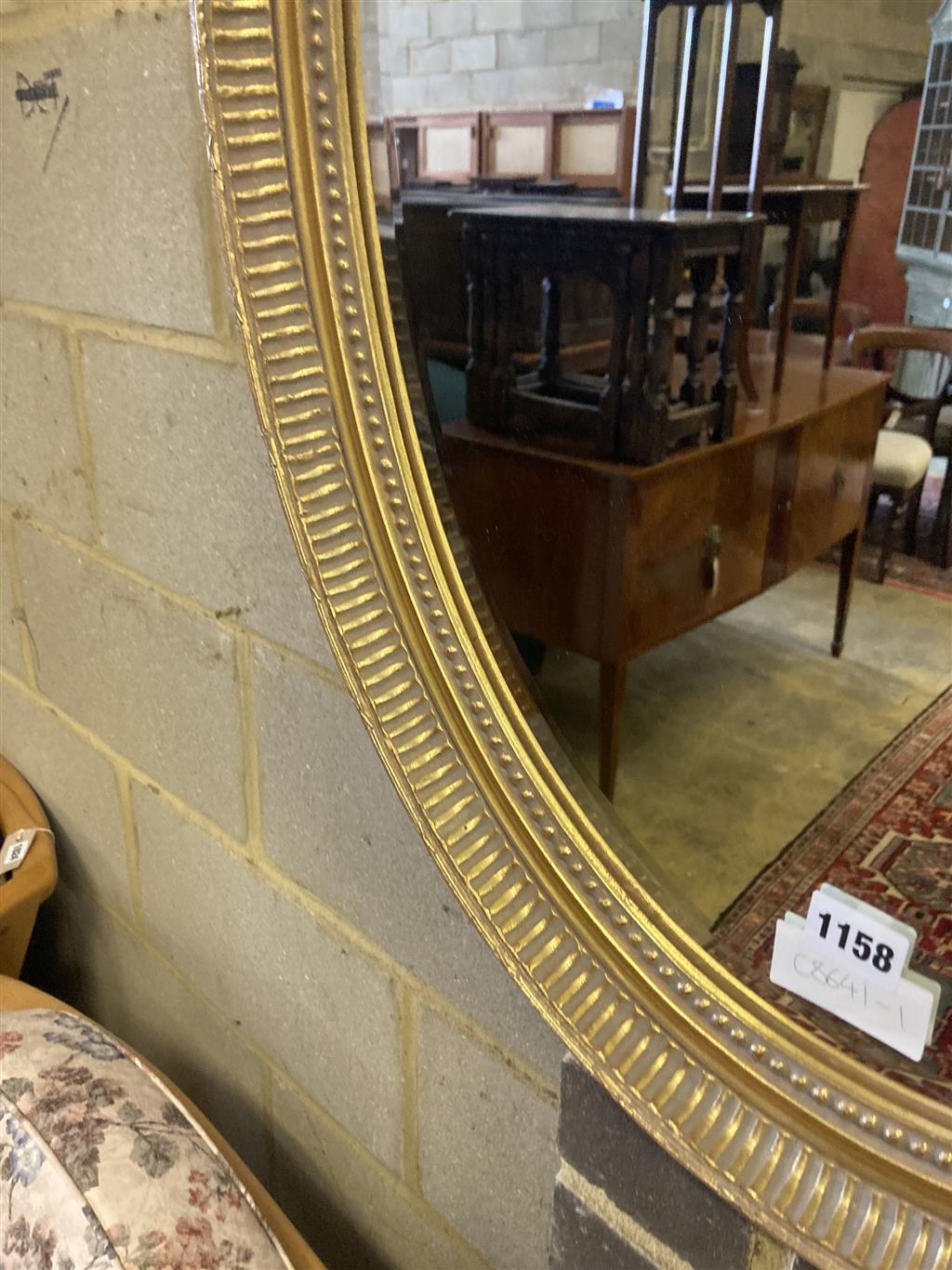 An oval gilt framed bevelled wall mirror, width 58cm height 78cm